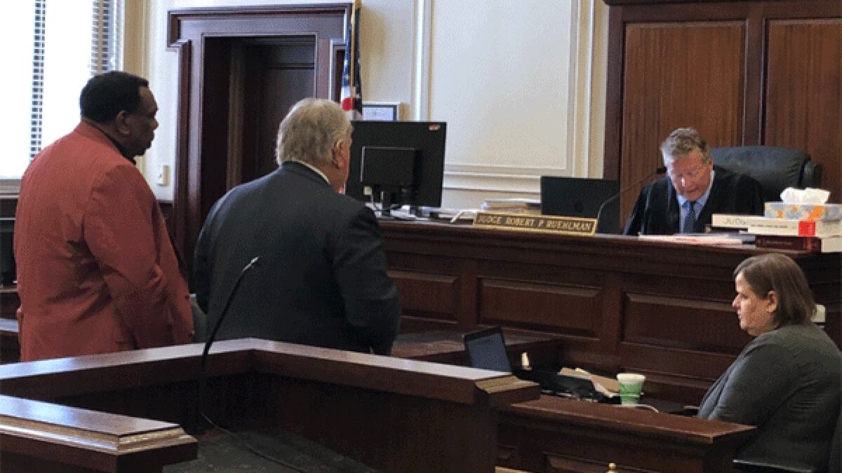 Cincinnati City Councilman Wendell  Young (left) and his lawyer, Scott Croswell (right) face...