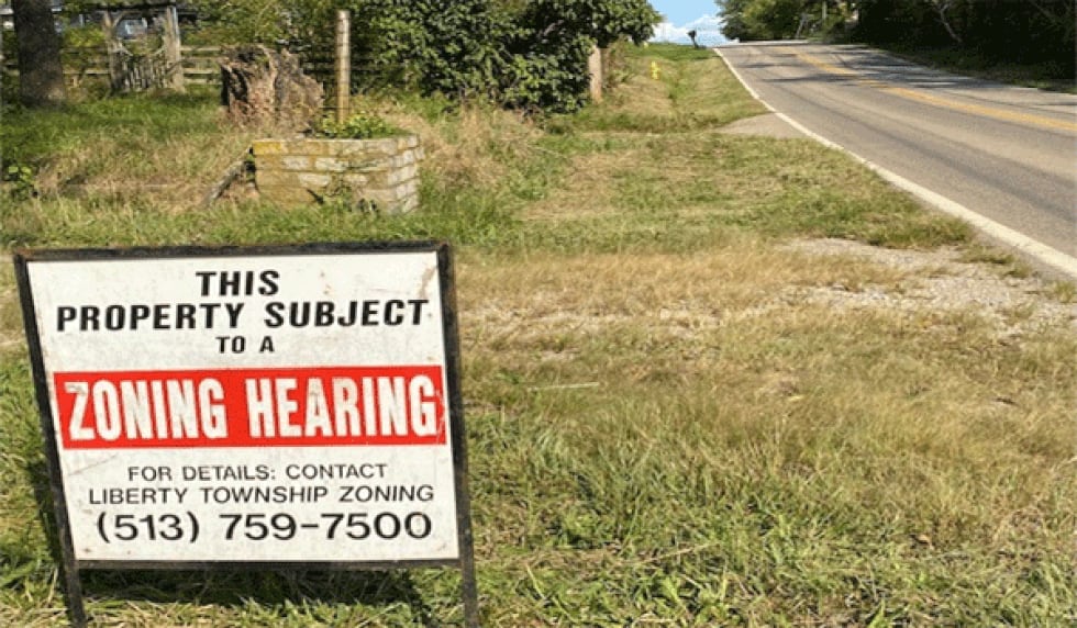 A sign advertises a Sept 21 zoning hearing for Gerald Parks' property on the north side of...