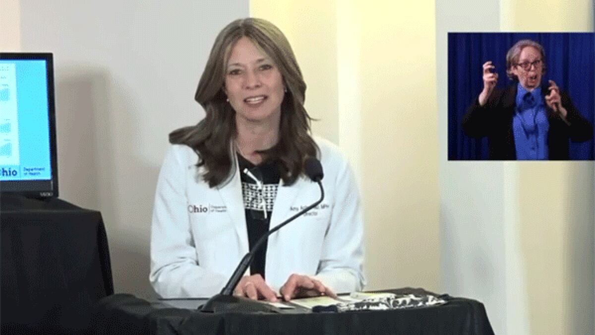 Ohio's top health official Dr. Amy Acton talks Thursday a news conference with Gov. Mike DeWine.