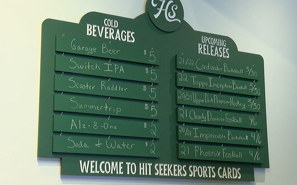 The shop includes a scoreboard that features upcoming releases and offered beverages.