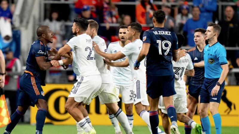 FC Cincinnati forward Sergio Santos (11) pushes Chicago Fire defender Mauricio Pineda (22) in...