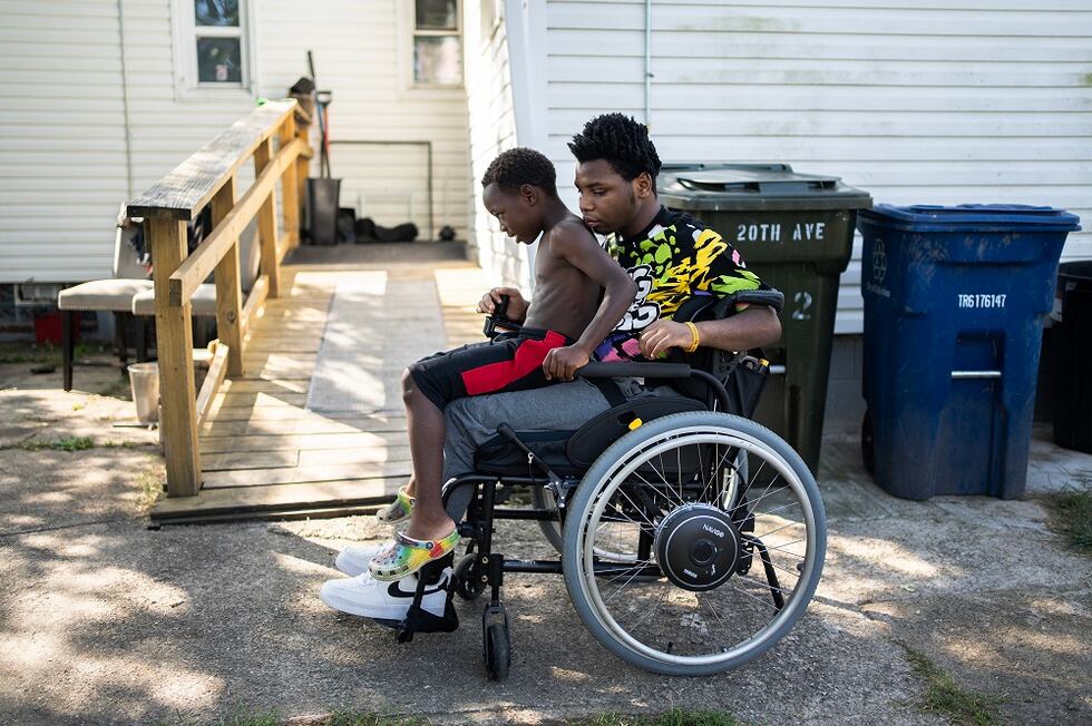 Sep 20, 2023; Columbus, Ohio, USA; Damarion Allen, 15, gives his youngest brother Woody, a...