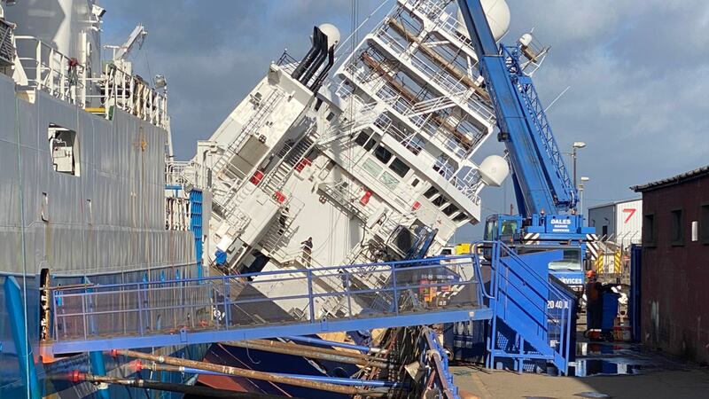 Photos shared on Twitter show the vessel tipped over at a 45-degree angle with emergency...