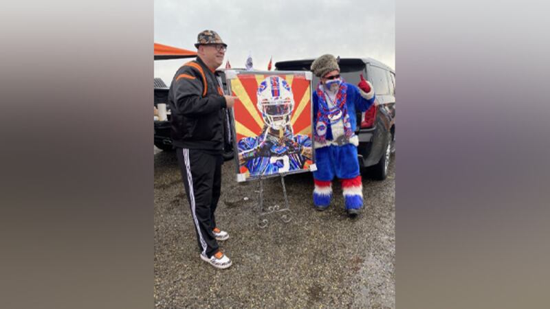 Gold Star Chili and Bengal Jim present a painted Damar Hamlin portrait to the Buffalo Bills as...