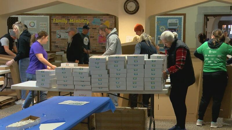 Volunteers with Meals on Wheels package pies to deliver to seniors for Thanksgiving.