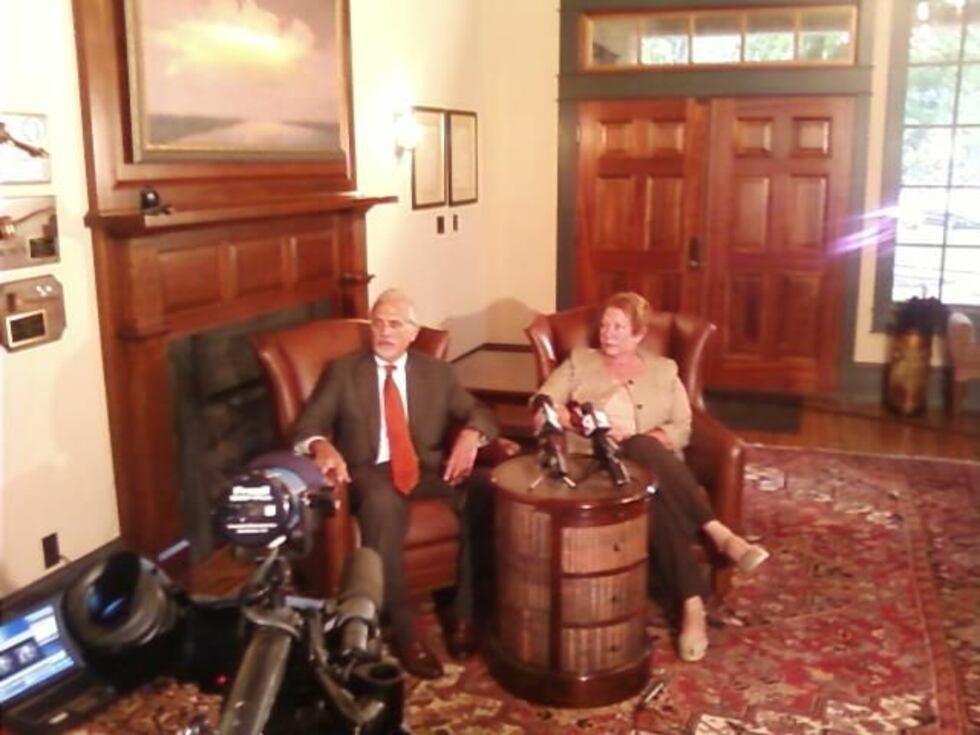 Defense attorney Charlie Rittgers and Jill Widmer talk to the media