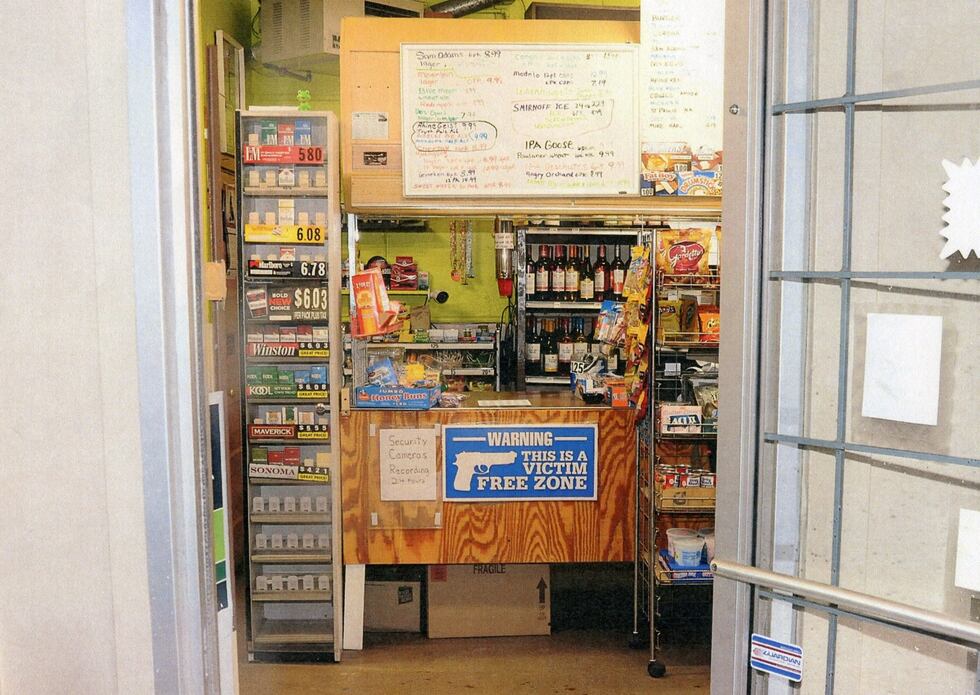 A sign at the counter of the Glenway Pony Keg reads "Warning: this is a victim free zone" with...