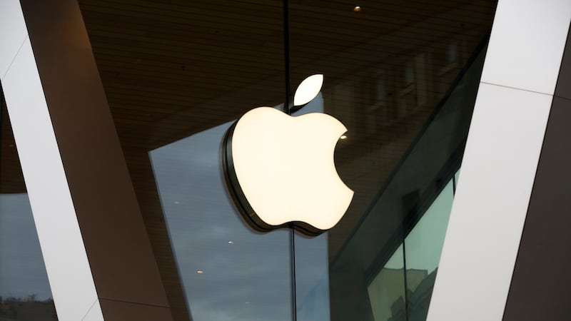 FILE - In this Saturday, March 14, 2020 file photo, an Apple logo adorns the facade of the...