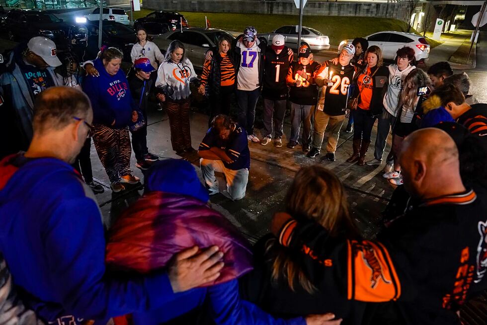 Fans gather outside of University of Cincinnati Medical Center, late Monday, Jan. 2, 2023, in...